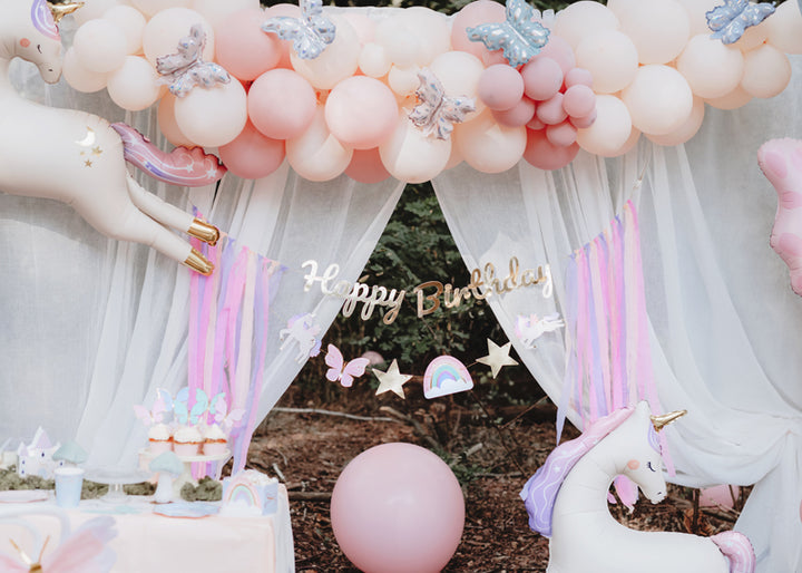 Girlang 2,3 m med unicornmotiv och texten Happy Birthday i guld. Dekorerad med ballonger till kalas och fest.